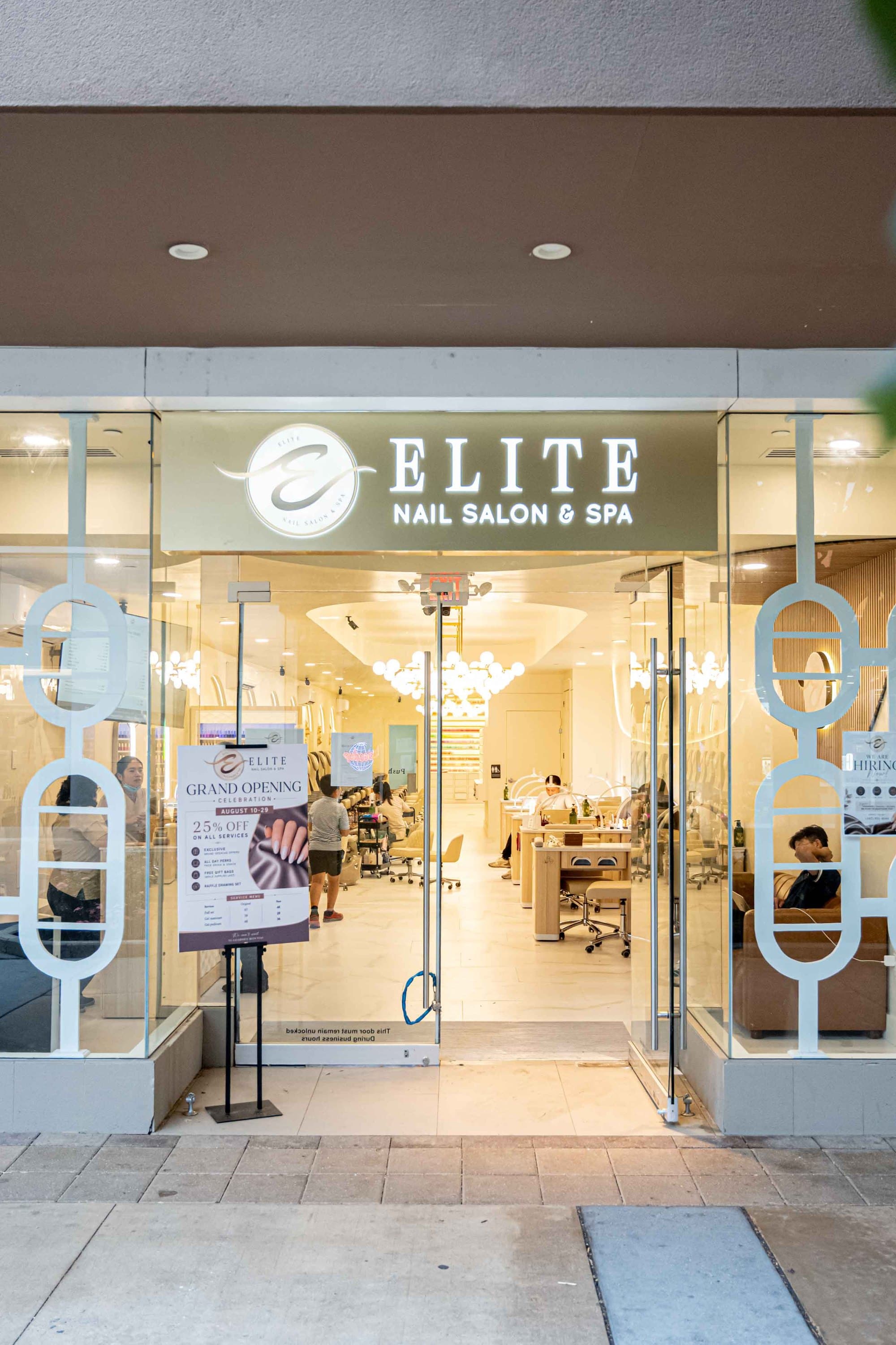 The lit Elite Nail Salon & Spa sign at the entrance, Cross County Shopping Center
