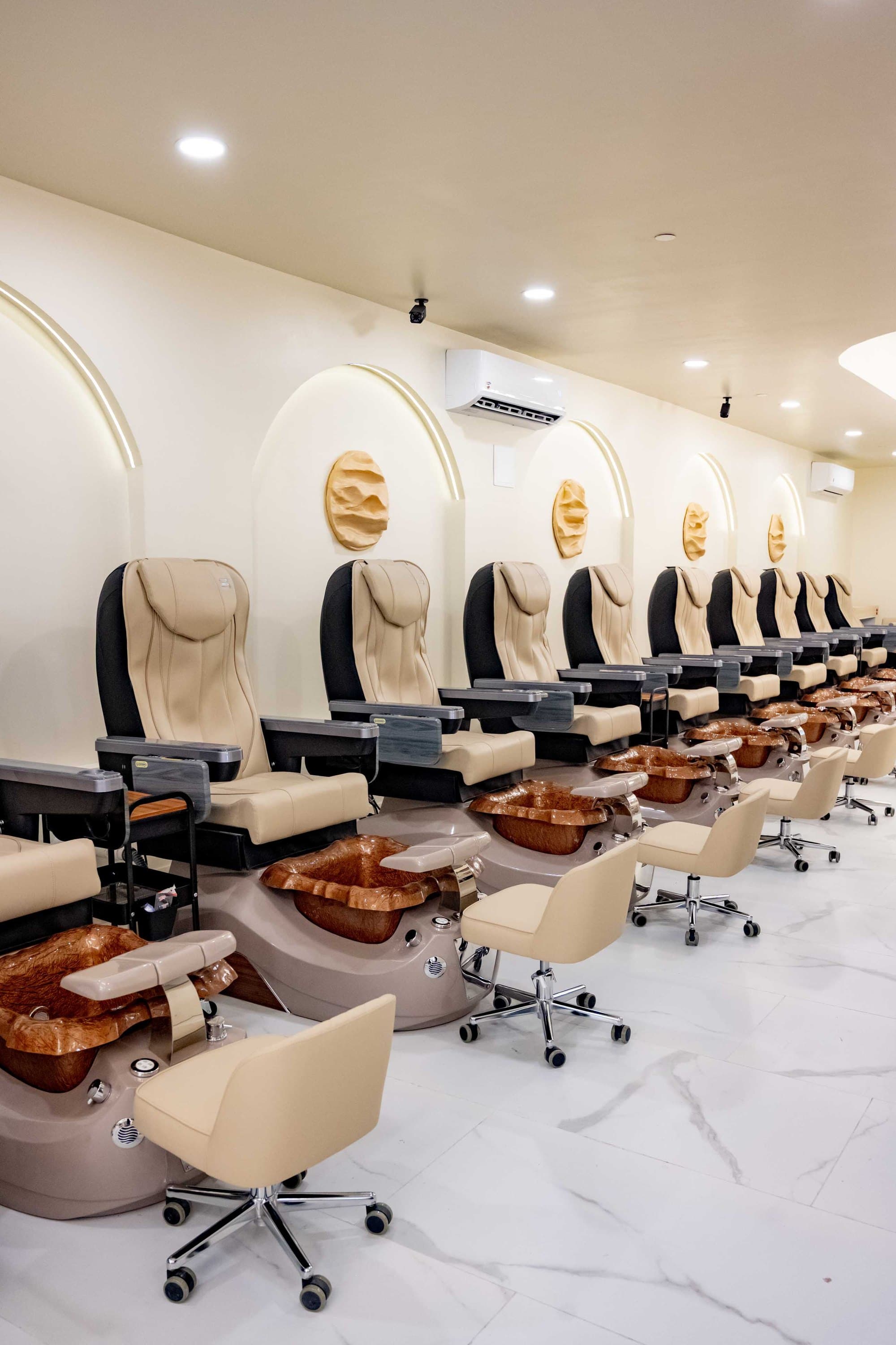 Pedicure chairs under lit arches at Elite Nail Salon & Spa, Cross County Shopping Center